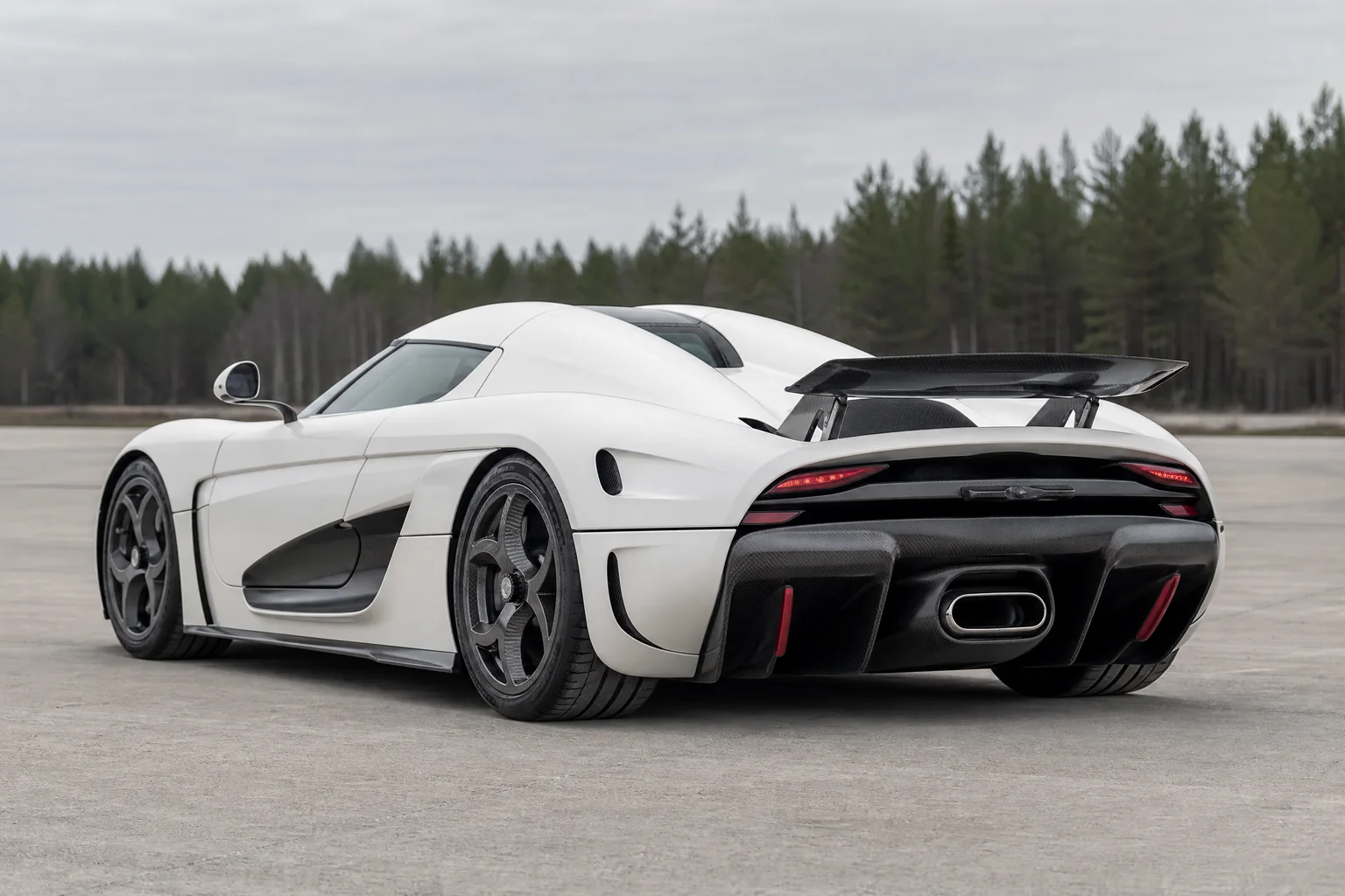 White Hästkraft Ström megacar, rear three-quarter view on a dry test-track apron
